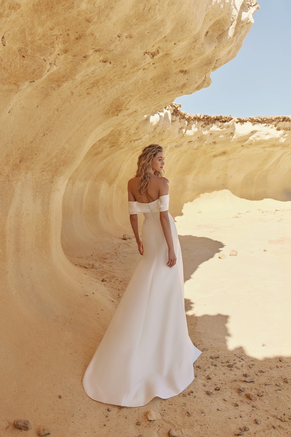 Yuma lace bridal gown with a structured off-shoulder draped overlay