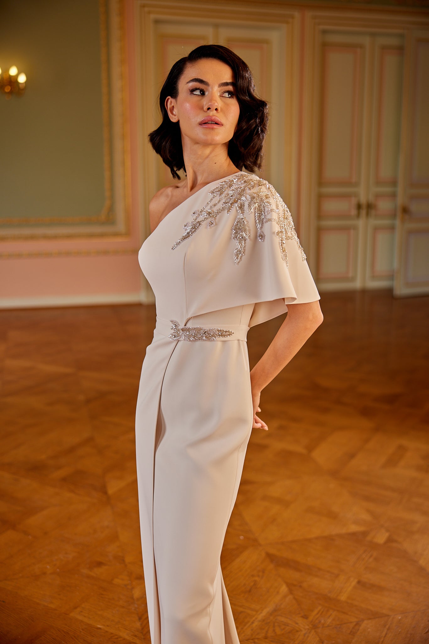 Luxury ivory evening dress featuring one-shoulder neckline and minimalist couture design