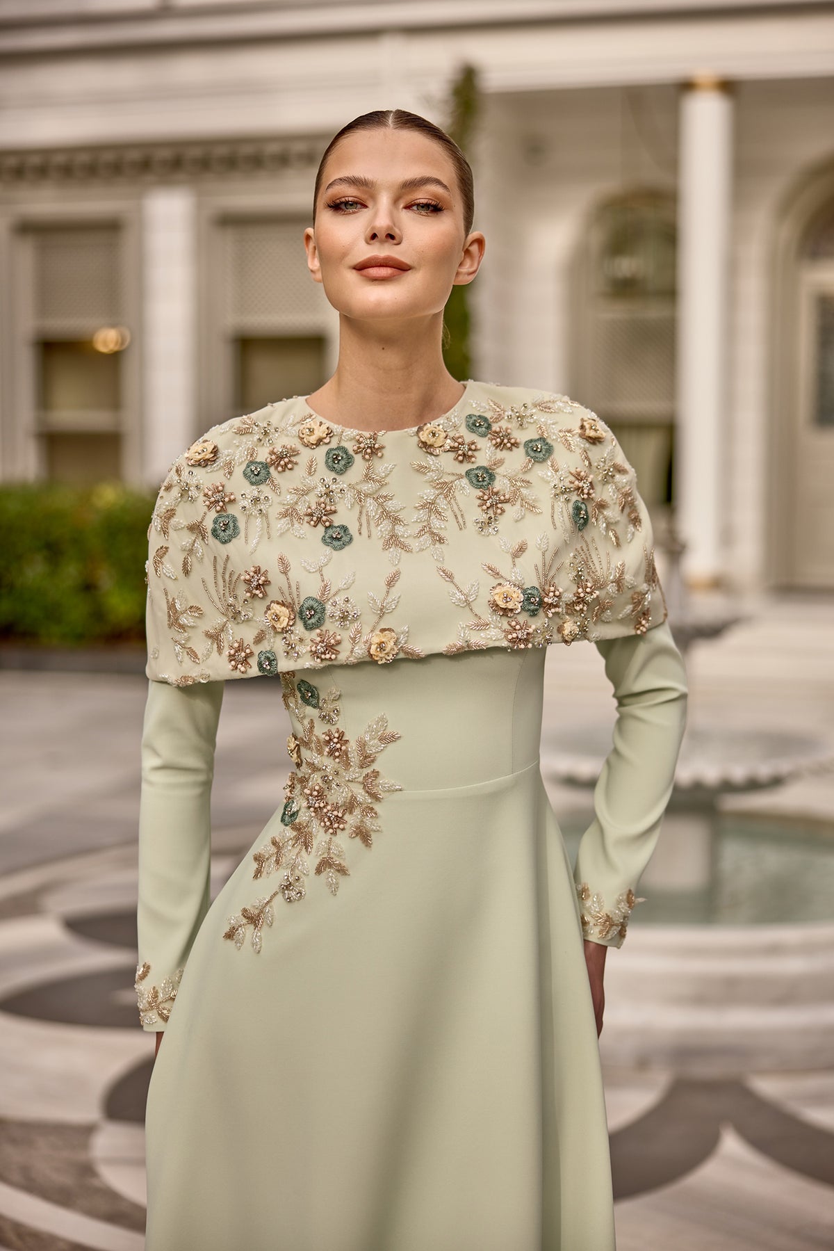 Elegant modest evening gown for weddings and gala nights with floral cape detail