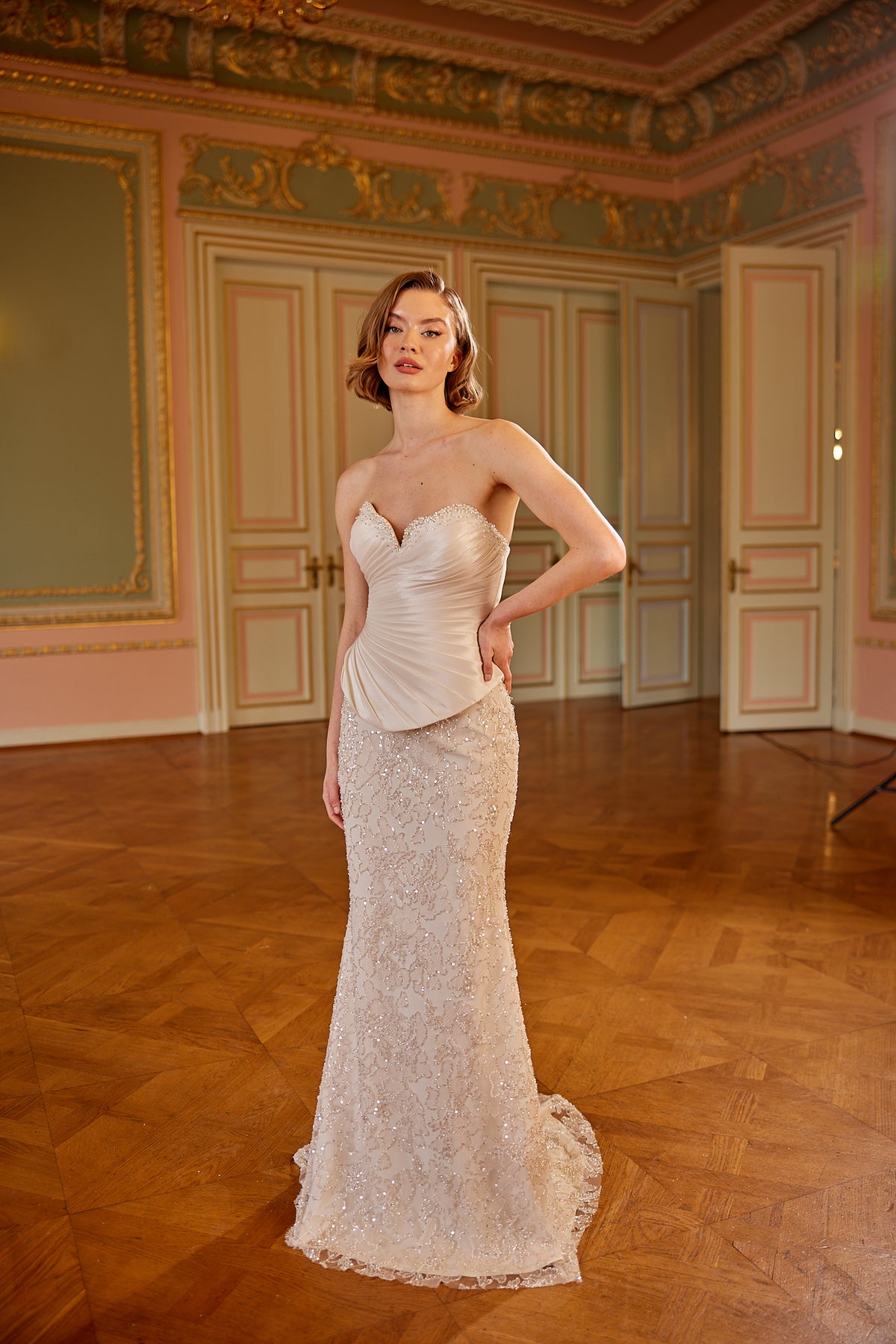 Strapless couture evening gown in nude tone with fitted silhouette and elegant detailing by Maison Harleen