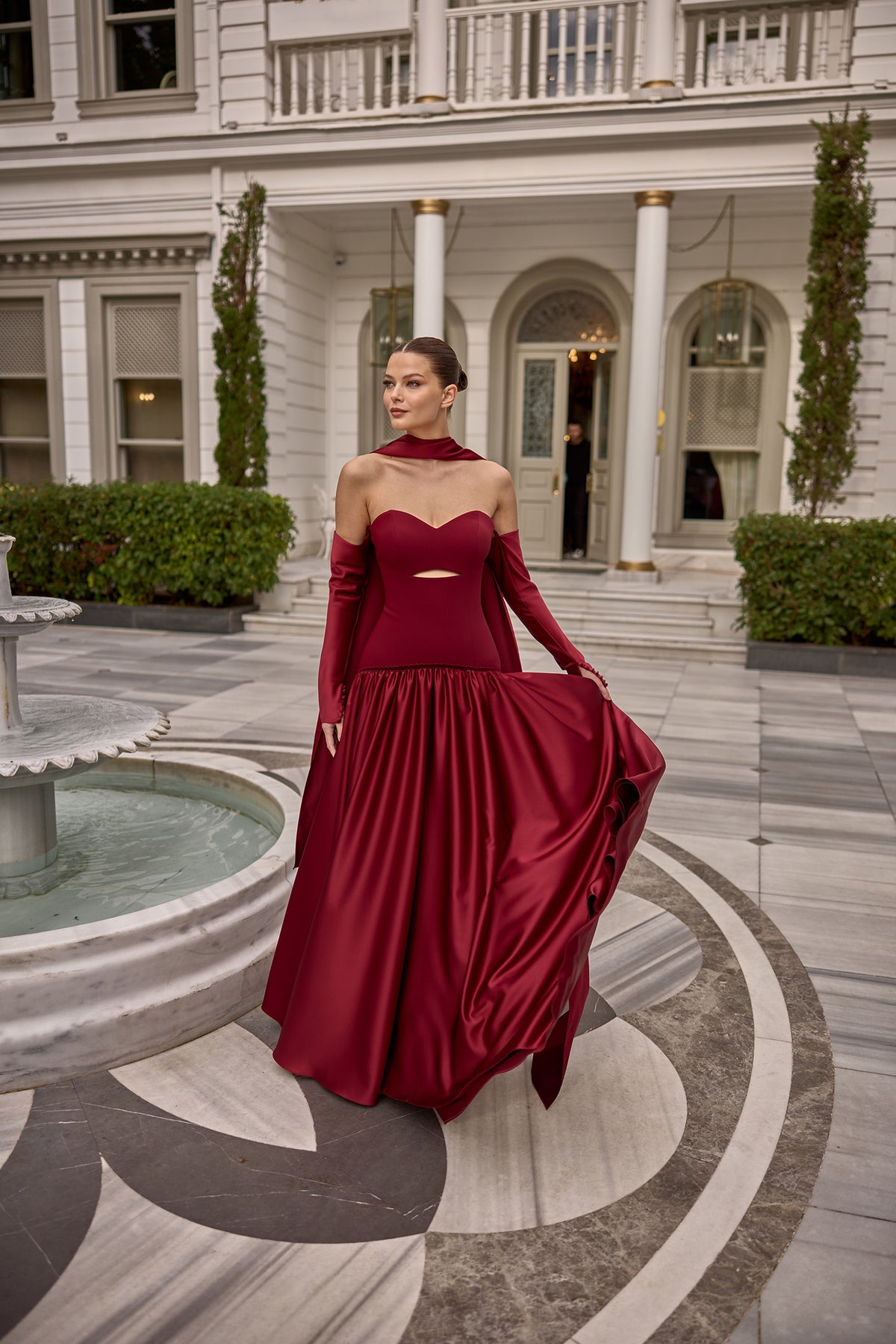 Elegant burgundy satin evening dress with opera gloves and flowing maxi silhouette