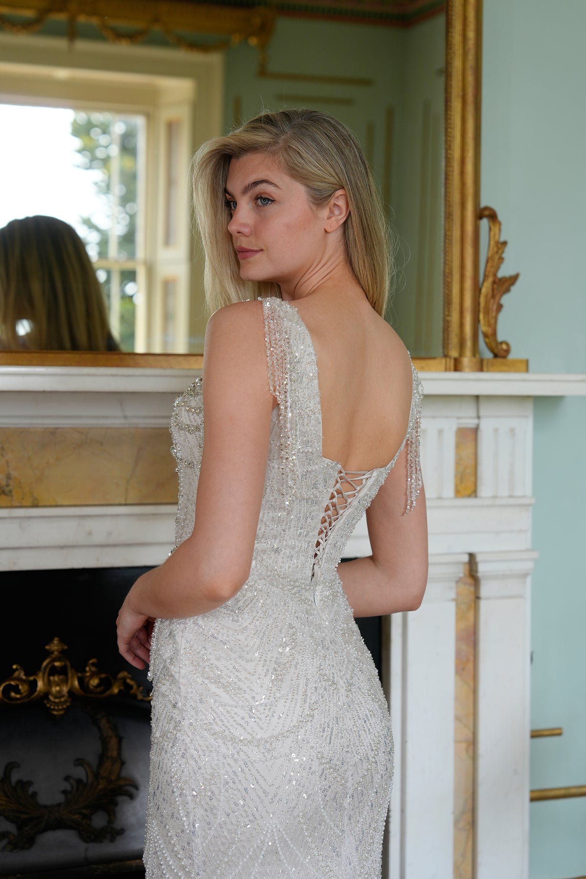 Virelle Crystal-Embellished Mermaid Evening Gown in Ivory — side profile displaying the fabric drape