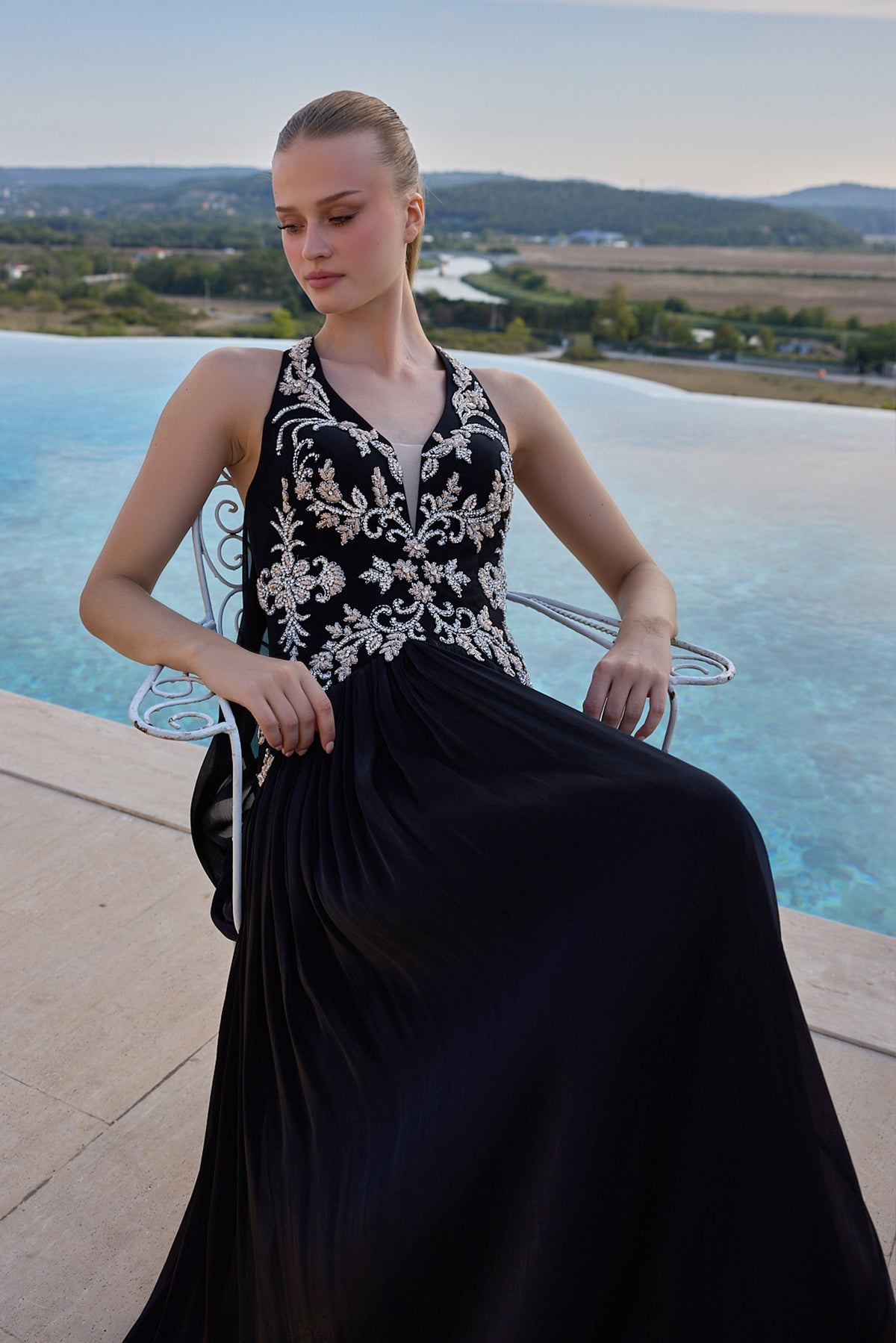 Maison Harleen eveningwear with a sculpted rose bodice and embroidered black skirt