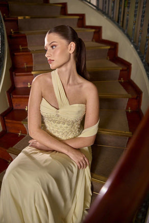 Champagne beige asymmetric couture evening gown with elegant draped bodice and refined silhouette by Maison Harleen