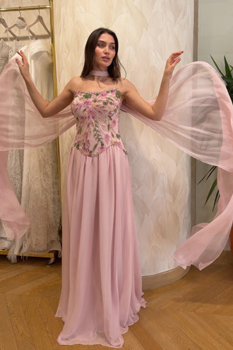 Luxury blush pink evening dress featuring elegant floral embellishments and couture styling