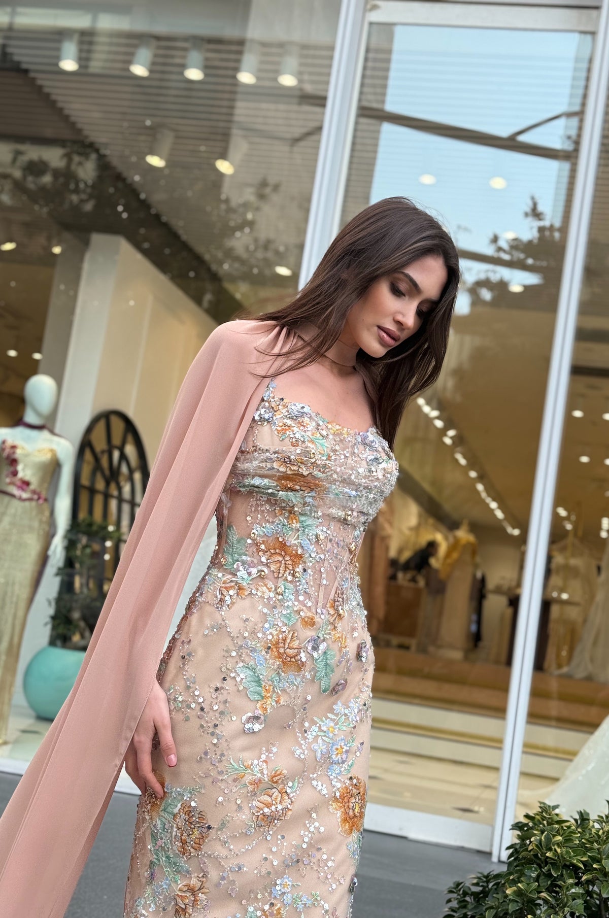 Luxury nude evening dress featuring delicate floral embellishments and couture styling