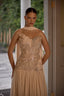 Luxury strapless evening dress featuring delicate embellishments and flowing scarf accent