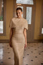 Model wearing Erin gold sequin couture gown with glamorous fitted silhouette