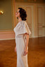 Minimal couture evening gown with sculpted silhouette and timeless one-shoulder styling