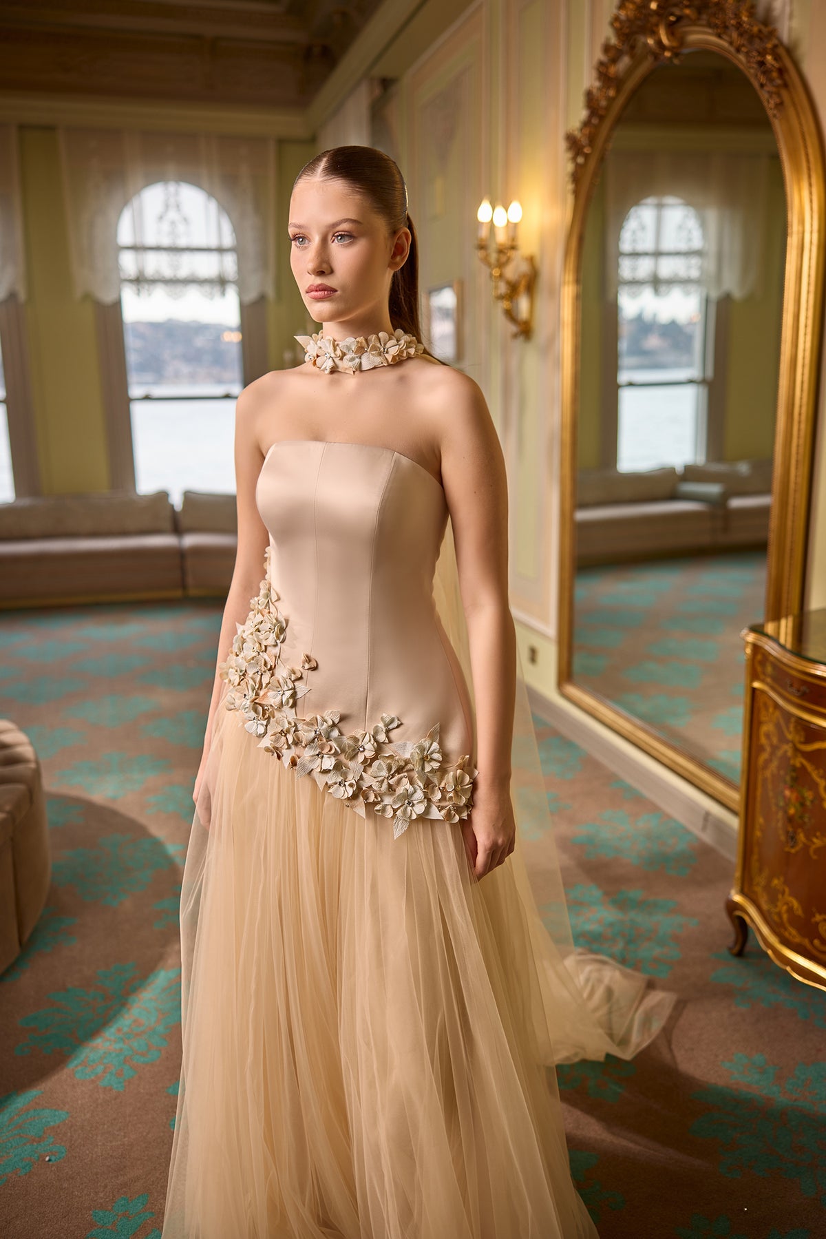 Sophisticated strapless evening dress with layered tulle skirt and floral accents