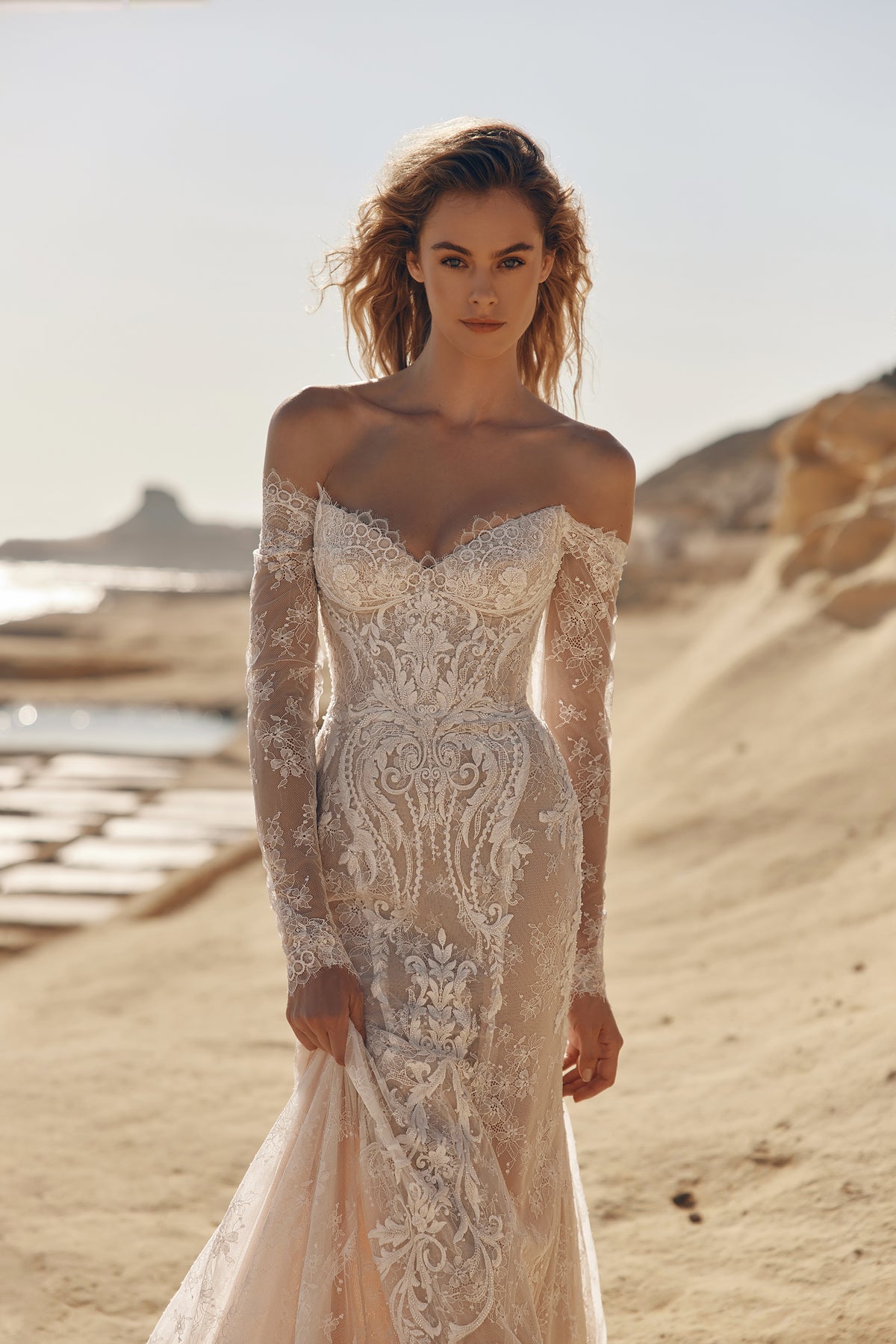 White lace long sleeve wedding dress with off shoulder detail and refined bridal elegance