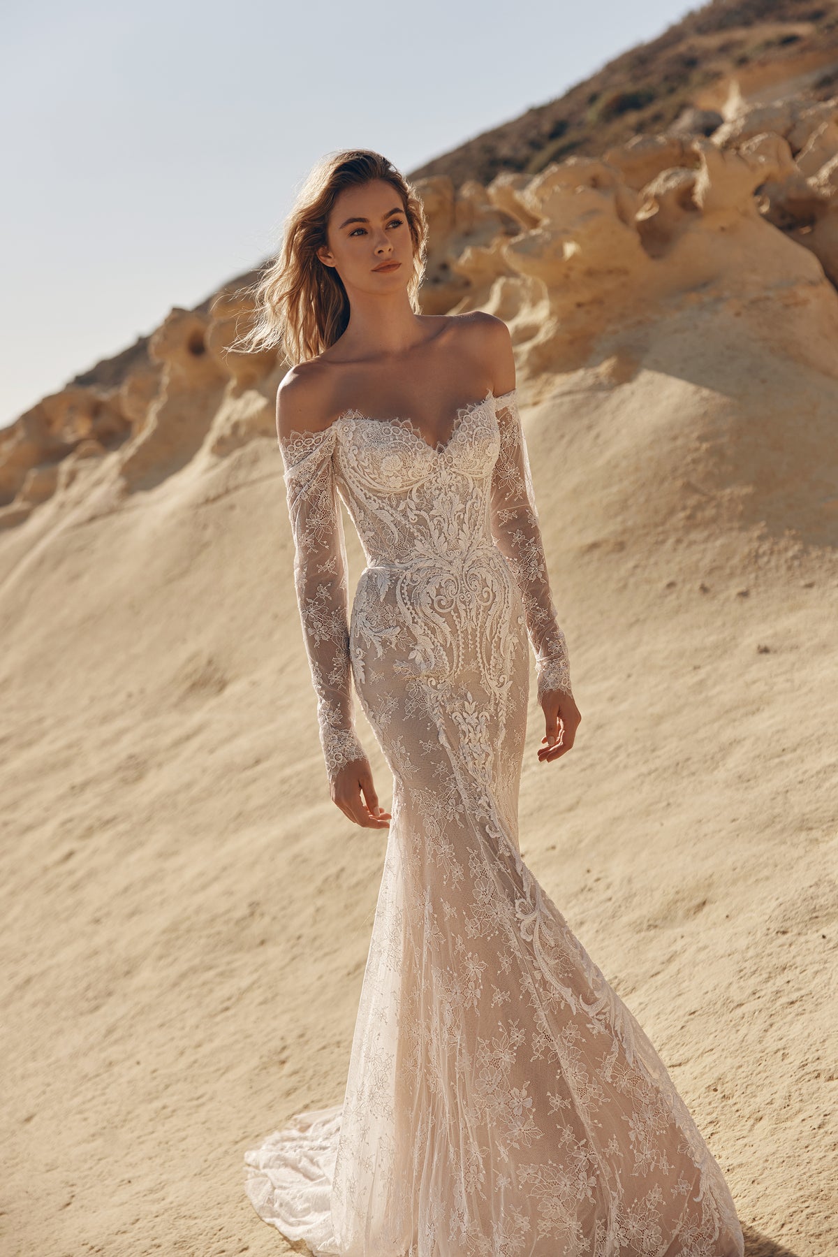 White modest couture bridal gown with lace detailing and elegant structured silhouette by Maison Harleen