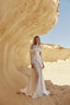 Yuma lace bridal gown with off-shoulder draped overlay and long sleeves in desert wedding setting